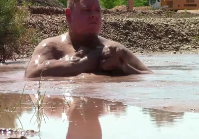 Deep, Creamy Brown Mud Bath in a Sand Pit