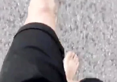 Jon Arteen Walks Barefoot on the Street Outdoors, the Boy Is Barefoot in the Crowded Tram to the Town Center